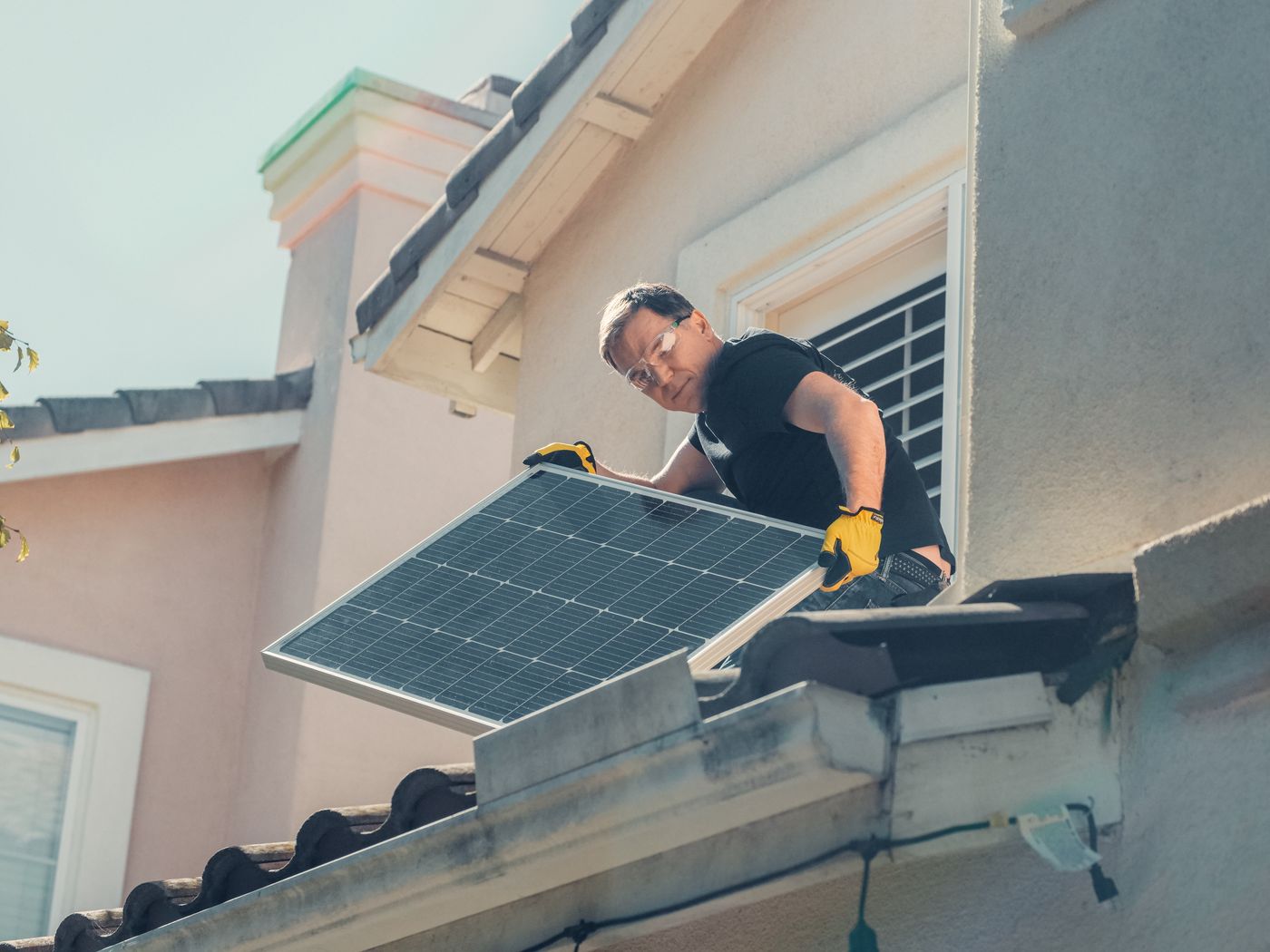 Axion technician installing solar panels